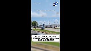 Road buckles due to heatwave, sending car airborne