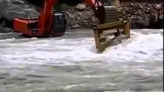 Dozer gets stuck crossing river, rescued by an excavator