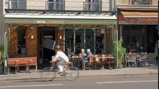 Street in Paris with small roadside cafes, France