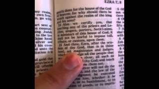 God's book in Ezra's hand.