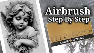 Airbrushing a stone cherub