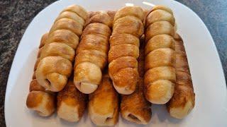 Сосиски в тесте жареные на сковороде. Sausages in dough fried in a frying pan.