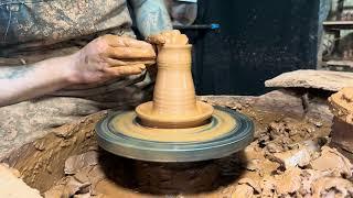 making a candlestick from clay on a potter's wheelИзготовление подсвечника из глины