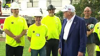 President Trump takes questions from reporters while attending flag pole construction
