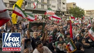 Iranians wave 'Down with USA' flags in streets of Tehran