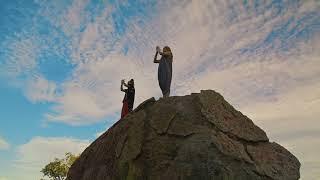 Videli Free Footage - Couple of people meditating on top of a rock