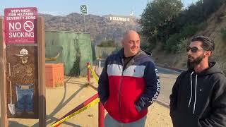 Locals check the Hollywood sign after seeing false reports of the iconic landmark burning