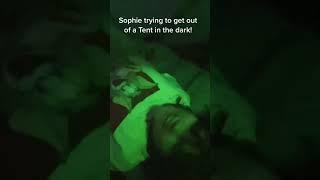 Sophie trying to get out of a tent in the dark