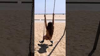 Sky Bri shows Lena the Plug up on the monkey bars at the beach 