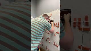 Process of laying tiles in a shower window.