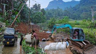 Excavator and cranes install culverts to build roads across streams and rural roads.