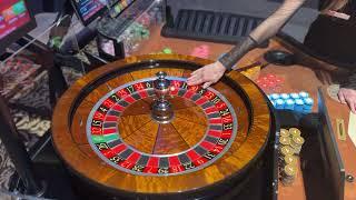 Casino dealer spins roulette ball