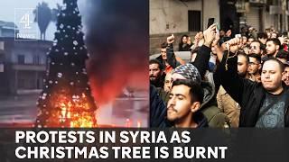 Hundreds protest in Syria after Christmas tree set alight