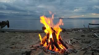 Swimming and bonfire at the nude beach with fable wood constructions, great clouds and still