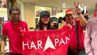 Anwar-led Pakatan Harapan supporters cheer as they await Malaysia GE15 results