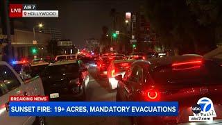 Traffic gridlock on Hollywood street as evacuations issued for Sunset Fire