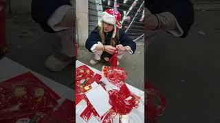 Italian girl whowas selling Chinese New Year goods ata stall on the street.Her hat is so authentic!