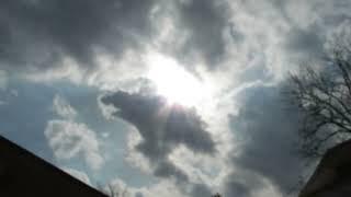 STRANGE SUN AMONG STRANGE CLOUDS