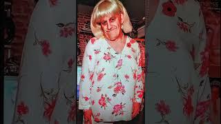 Wendy wearing a white satin rose blouse from asda