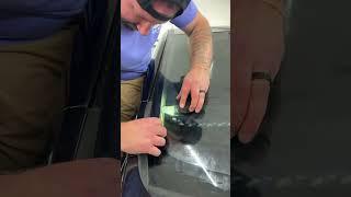 Hand cutting the windshield with the help of the Xact Lite