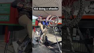 KID DOES A WHEELIE  ON A 2 STROKE YAMAHA YZ