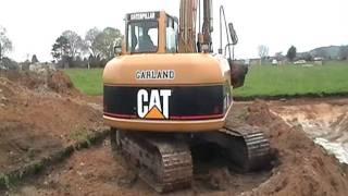 cat 312c excavator ,excavating a silt pond