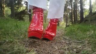 Red stiletto boots and white jeans through forest