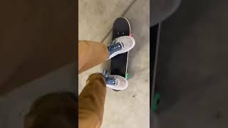 Doing tricks on a mini skateboard 1/4 of the size of mine