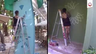 Lauren Napolitano painting murals at Tao Inspired Living Community.