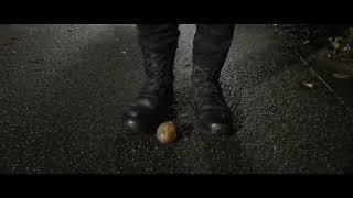 Tactical boots stomp unknown fruit during a night hike