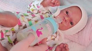 Reborn baby doll feeding and changing clothes and diapers