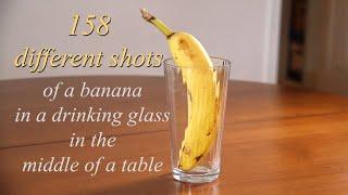 158 DIFFERENT SHOTS OF A BANANA IN A DRINKING GLASS IN THE MIDDLE OF A TABLE