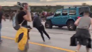 Car drives at crowd of protesters in Aurora, Colorado