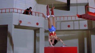 Wonder Woman hanging upside down to break open a safe