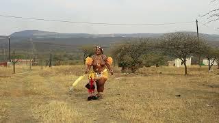 ZULU GIRL WALKING WHILE HOLDING SOFT DUSTER BRUSH