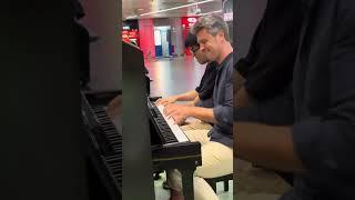 Playing piano in four hands at subway station in the Singapore