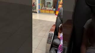 Little girl sitting in massage chair