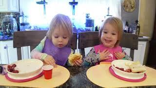 Twins drink out of an open cup