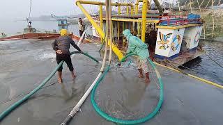 At the start of the work the workers are lifting sand with dredger machines during the winter season