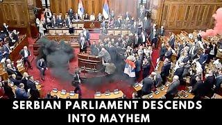 Serbian Lawmakers Brawl! Smoke Fills Parliament as MP Suffers Stroke