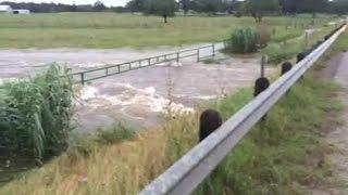 Water over roadway in Paige