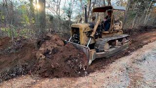 70 year old bulldozer working hard along with new equipment to improve the driveway drainage