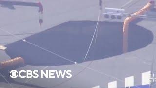 Swimming pool-sized sinkhole traps truck driver in Japan