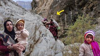 Khadija and her children return to their wooden hut in the rain