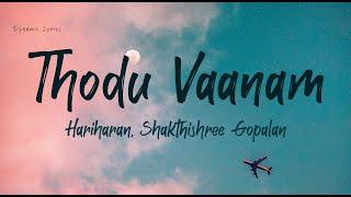 Thodu Vaanam Lyrics -  Anegan | Harish Jayaraj | Hariharan | Shakthishree Gopalan