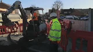 severn trent workmen dig a hole / digger action and grab action