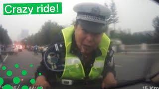 POLICEMAN DRAGGED ON CAR BONNET FOR 2KM
