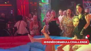 Blonde Girl in White Clothes Riding on a Mechanical Bull in Benidorm | 4K