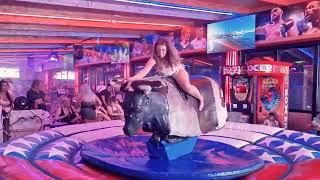 Pretty Girl in Beautiful Dress Riding on a Bull in Benidorm | Mechanical Bull 4K. Epic Fail August