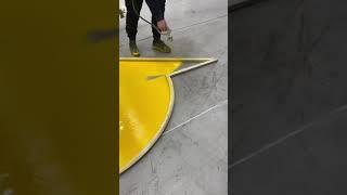 Spray painting a turn arrow on pavement